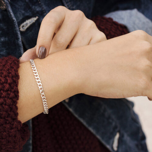 sterling silver curb chain bracelet with a hook clasp worn by a woman
