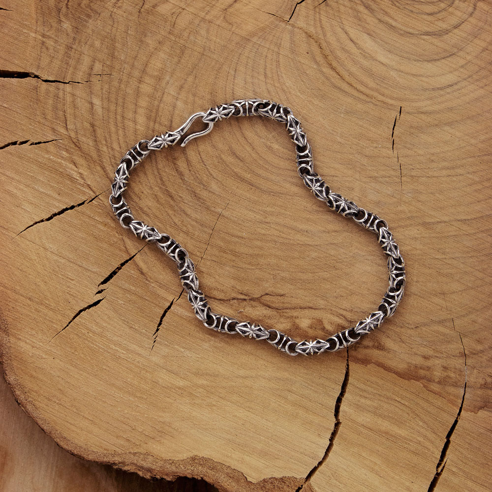 Artisan Bracelet in Solid Sterling Silver with Oxidized Finish on wooden background