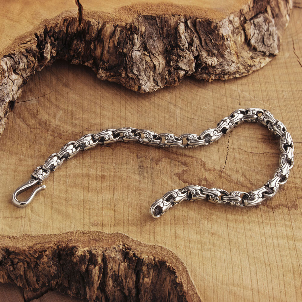 silver beaded chain link bracelet with an oxidized finish on wooden background