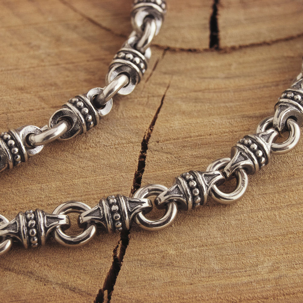 Silver Chain Bracelet with Beads and Links on wooden background