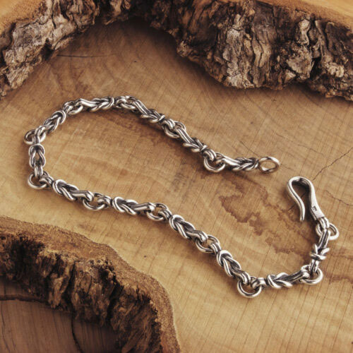 Silver Knot Bracelet with an Oxidized Finish on Wooden Background