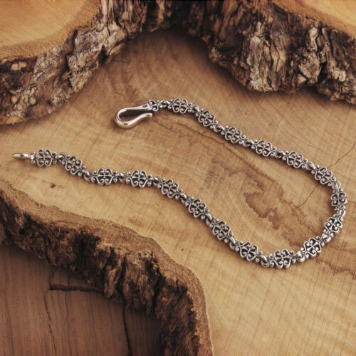 Silver Chain Bracelet with a Floral Design on Wooden Background
