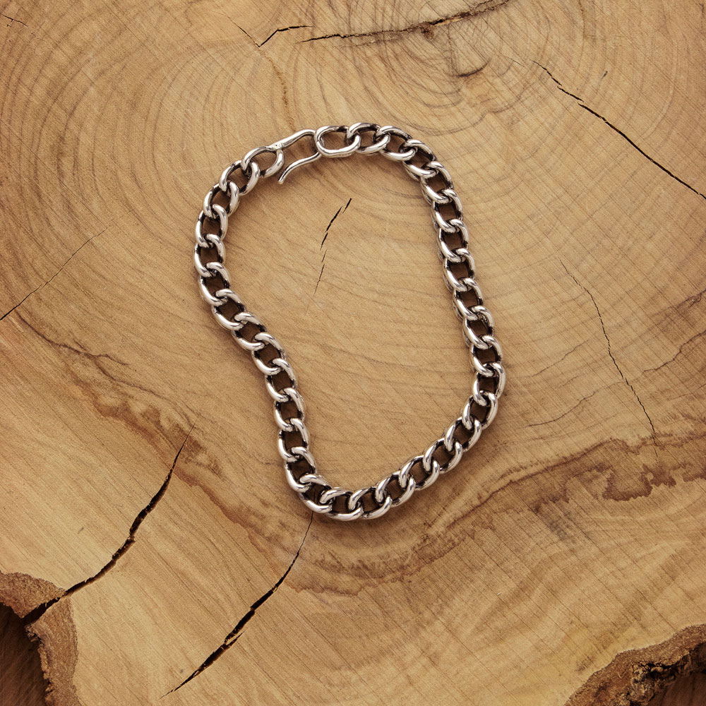 Wheat Bracelet with an Oxidized Finish on a Wooden Background