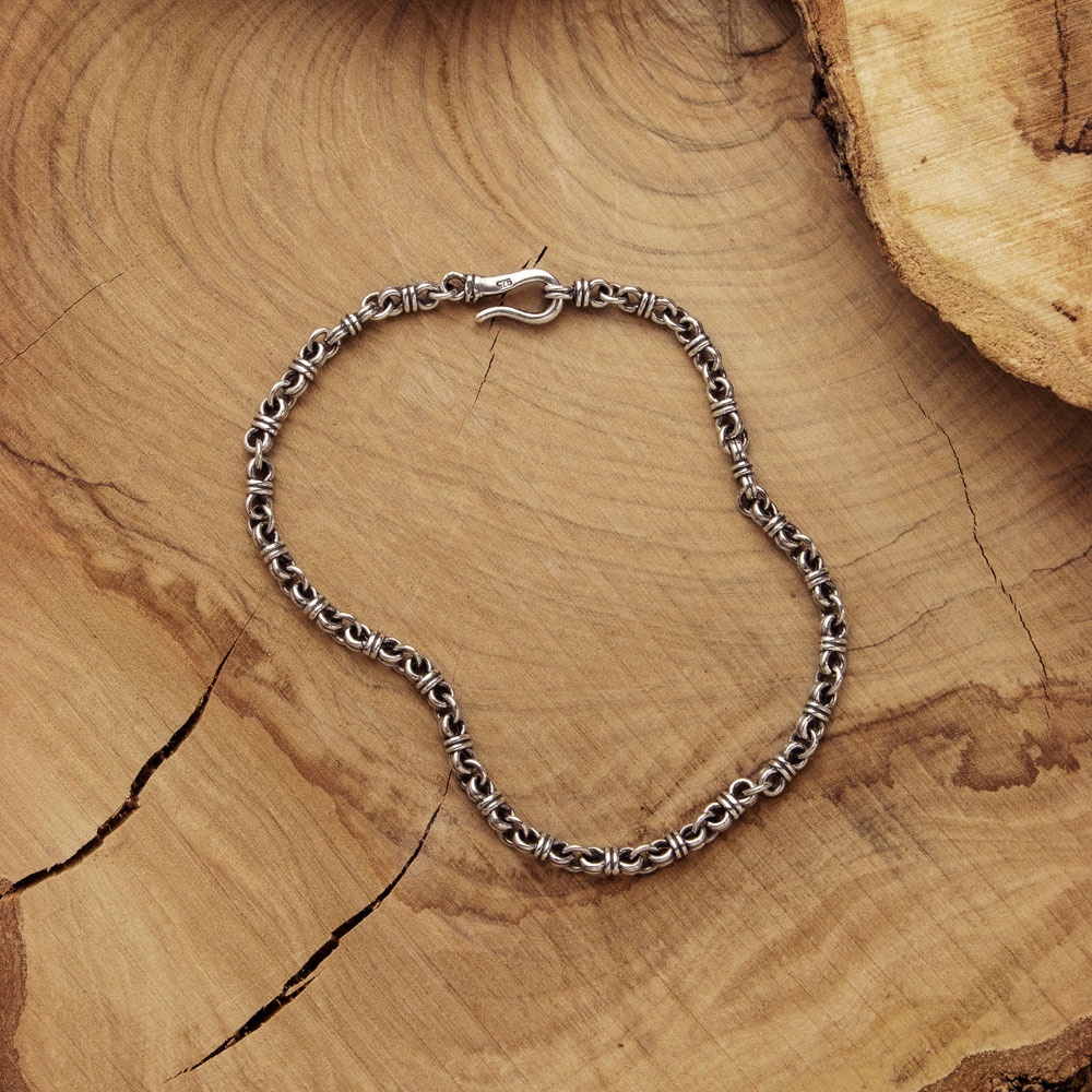 Chain Link Bracelet with Wire Links on a Wooden Surface