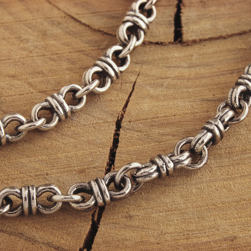 Chain Link Bracelet with Wire Links on a Wooden Surface