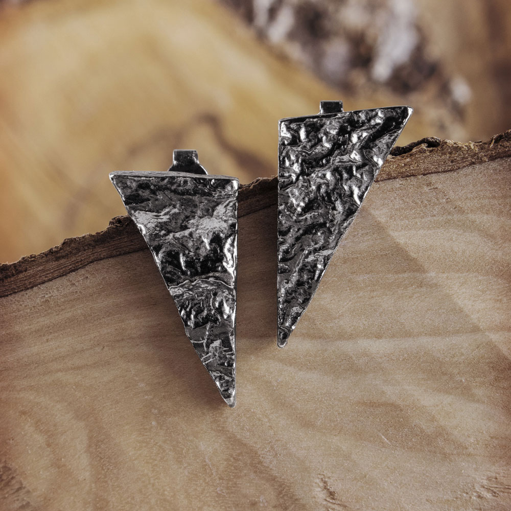 Silver Triangle Earrings with an Oxidized Textured Surface on a Wooden Surface