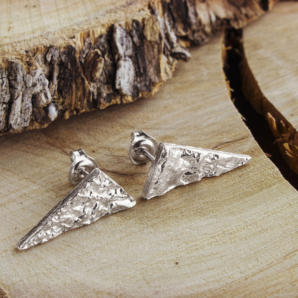 Rustic Stud Earrings with a Triangle Shape on a Wooden Background