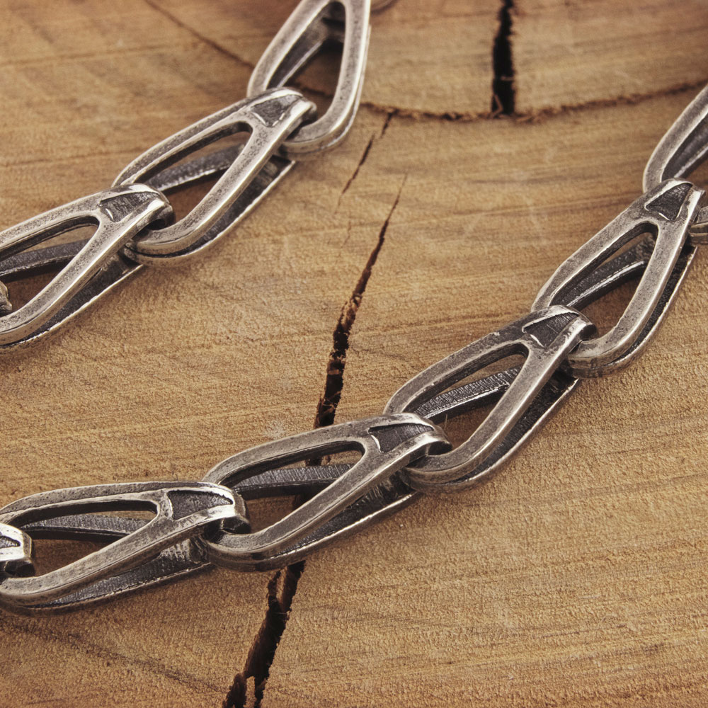 curved link chain necklace in oxidized sterling silver on a wooden background