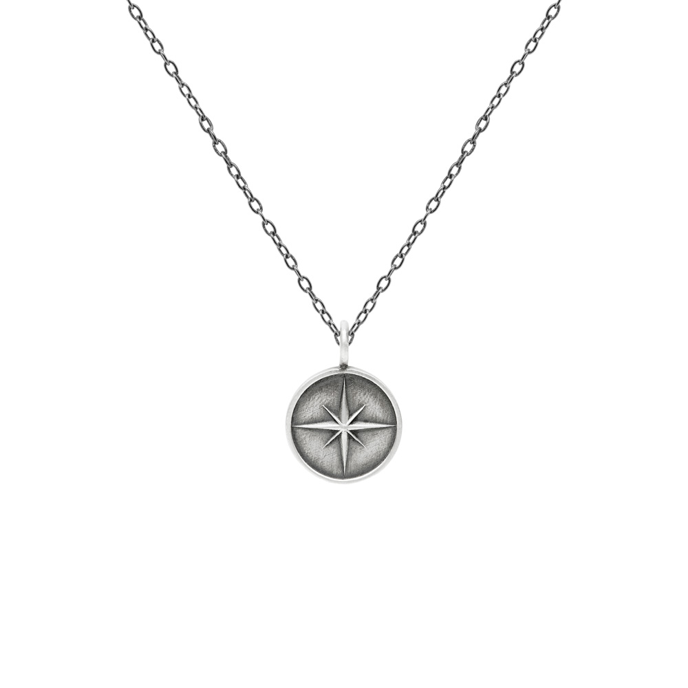 Silver Compass Pendant Necklace with an Oxidized Finish with a chain on a white background
