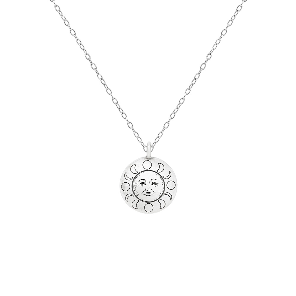Sun Face Pendant Necklace in Oxidized Silver and a long chain displayed on a white background